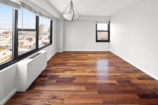 135 Montgomery St Unit A-19, Jersey City, NJ 07302 - empty room with wood finished floors and a view of city
