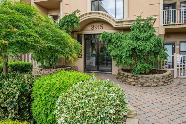 8915 Bergenwood Ave Unit 48, North Bergen, NJ 07047 - view of exterior entry with stucco siding and a balcony