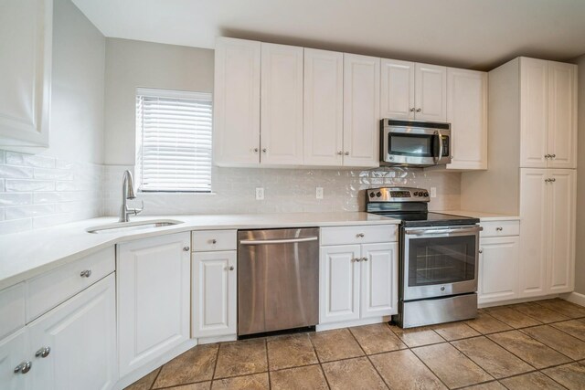 8915 Bergenwood Ave Unit 48, North Bergen, NJ 07047 - kitchen featuring appliances with stainless steel finishes, a sink, and light countertops