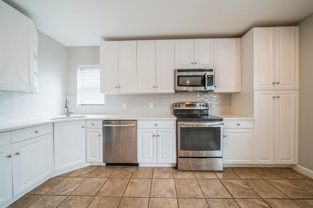 8915 Bergenwood Ave Unit 48, North Bergen, NJ 07047 - kitchen with appliances with stainless steel finishes, a sink, light countertops, white cabinets, and decorative backsplash
