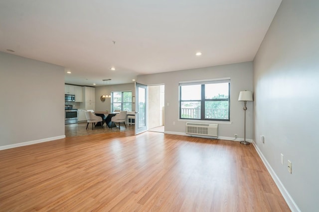 8915 Bergenwood Ave Unit 48, North Bergen, NJ 07047 - unfurnished living room featuring light wood-type flooring, baseboards, recessed lighting, and a wall mounted air conditioner