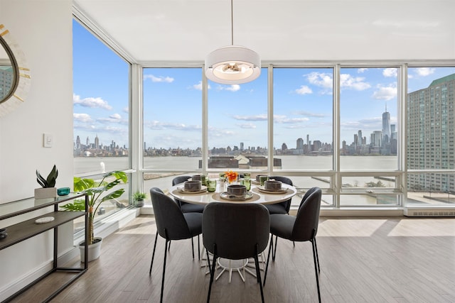 sunroom / solarium with a water view and a city view