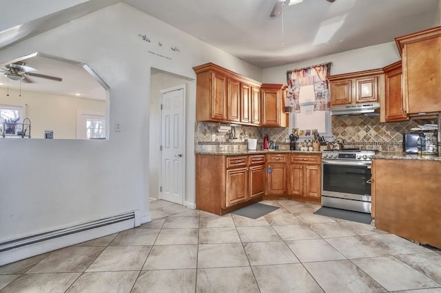 kitchen featuring a baseboard radiator, stainless steel range oven, a ceiling fan, and under cabinet range hood