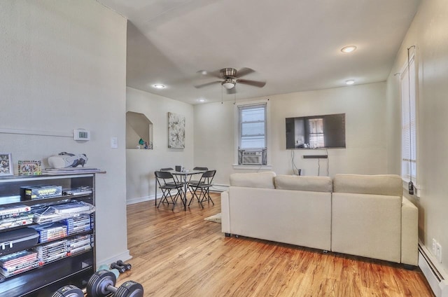 living room with ceiling fan, baseboard heating, light wood finished floors, cooling unit, and recessed lighting