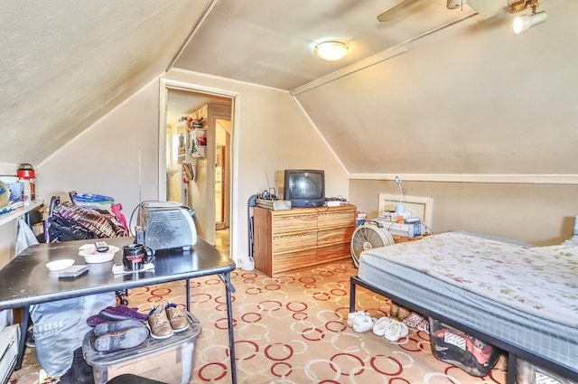 bedroom featuring a baseboard heating unit, vaulted ceiling, and carpet floors