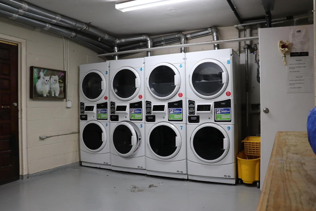 laundry room featuring washing machine and clothes dryer and stacked washer / dryer