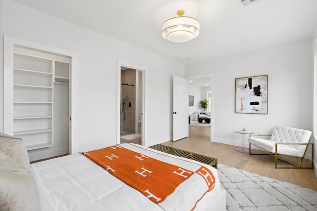 35 Orchard St Unit 301, Jersey City, NJ 07306 - bedroom with baseboards, ensuite bathroom, wood finished floors, and a closet