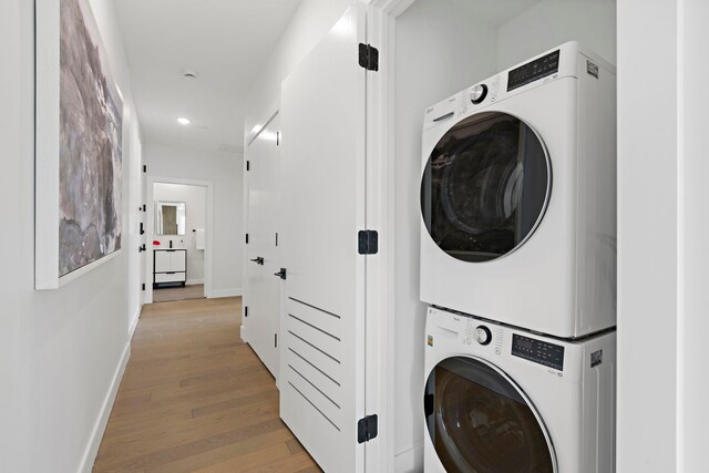 35 Orchard St Unit 301, Jersey City, NJ 07306 - washroom featuring laundry area, stacked washer and dryer, light wood-type flooring, baseboards, and recessed lighting