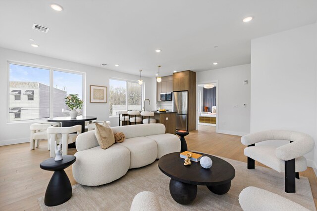 35 Orchard St Unit 301, Jersey City, NJ 07306 - living room featuring recessed lighting, baseboards, and light wood finished floors