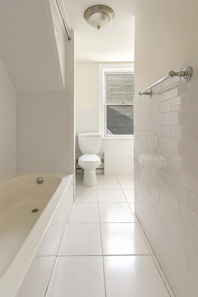 12 W 31st St, Bayonne, NJ 07002 - full bath with tile walls, toilet, tile patterned flooring, tub / shower combination, and a wainscoted wall