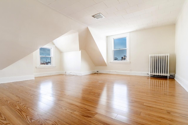 12 W 31st St, Bayonne, NJ 07002 - additional living space featuring radiator heating unit, wood finished floors, lofted ceiling, and baseboards