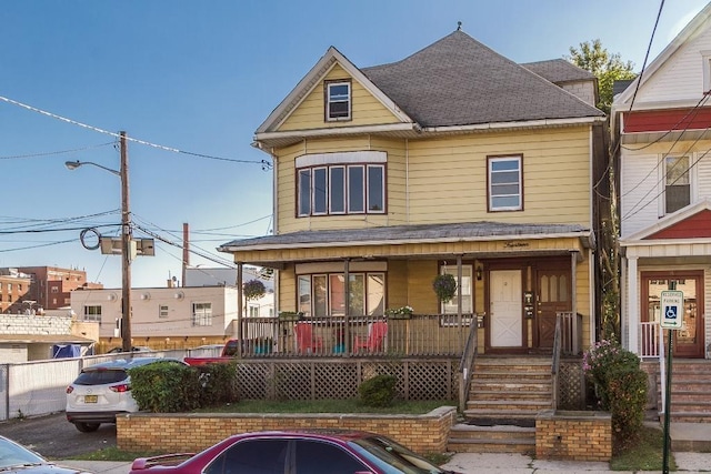 12 W 31st St, Bayonne, NJ 07002 - view of front of home featuring covered porch and roof with shingles