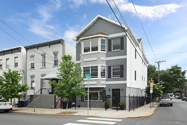 4 Sherman Ave Unit 1, Jersey City, NJ 07307 - view of property with brick siding and a fenced front yard