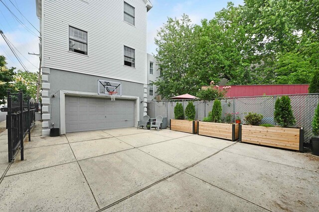 4 Sherman Ave Unit 1, Jersey City, NJ 07307 - view of property exterior with stucco siding, a garage, and driveway