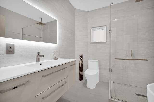 2505 Palisade Ave, Union City, NJ 07087 - full bathroom with a stall shower, tile walls, toilet, and vanity