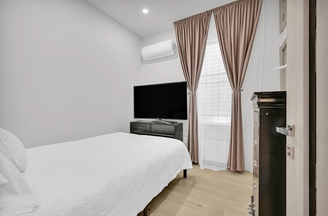 2505 Palisade Ave, Union City, NJ 07087 - bedroom featuring a wall mounted air conditioner, light wood finished floors, and recessed lighting
