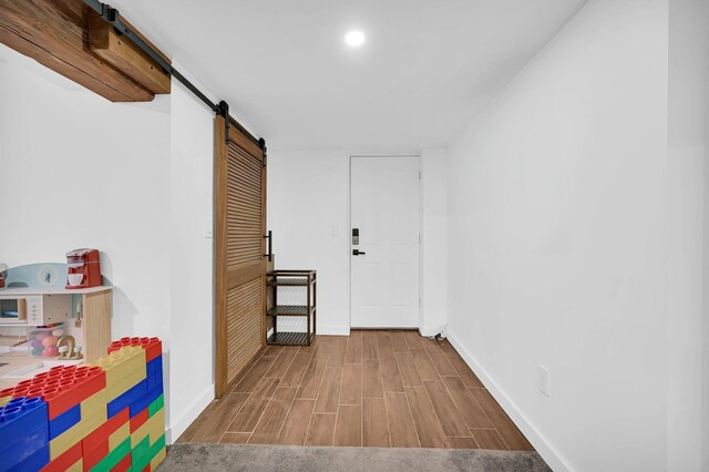 2505 Palisade Ave, Union City, NJ 07087 - hall featuring a barn door, baseboards, wood finished floors, and recessed lighting