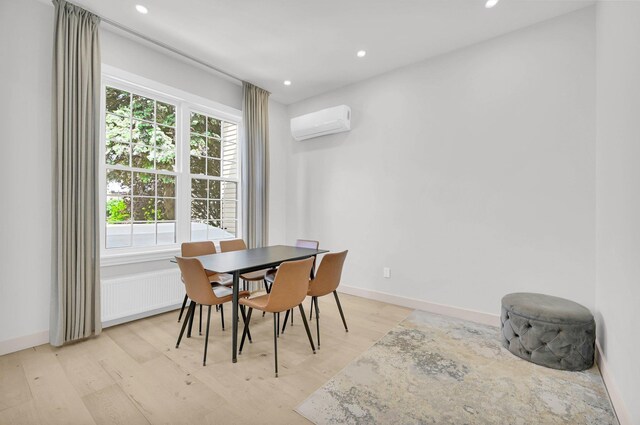 2505 Palisade Ave, Union City, NJ 07087 - dining space with an AC wall unit, light wood-style flooring, recessed lighting, and baseboards