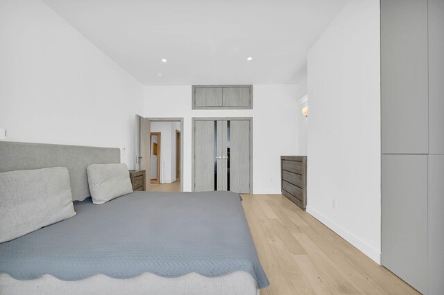 2505 Palisade Ave, Union City, NJ 07087 - bedroom with light wood finished floors, recessed lighting, a closet, and baseboards