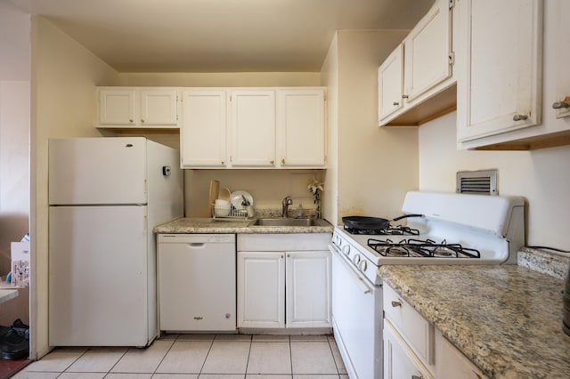 135 Montgomery St Unit 6D, Jersey City, NJ 07302 - kitchen featuring white appliances, white cabinetry, light countertops, and light tile patterned flooring