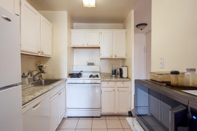 135 Montgomery St Unit 6D, Jersey City, NJ 07302 - kitchen with white appliances, white cabinetry, and light tile patterned floors