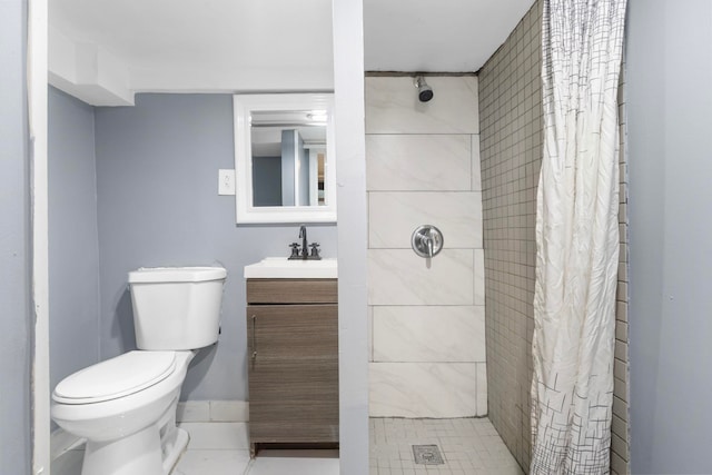 bathroom with vanity, toilet, baseboards, and a stall shower