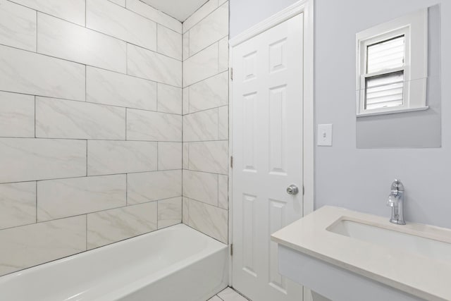 bathroom with bathtub / shower combination and a sink