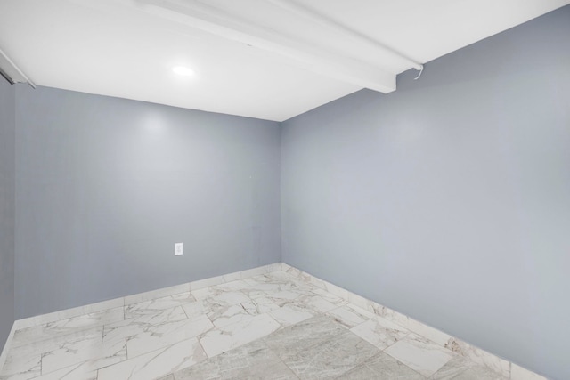 spare room with beam ceiling, baseboards, and marble finish floor