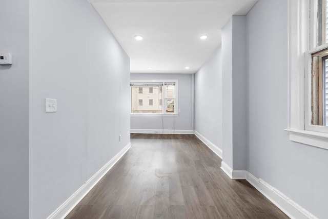 corridor with recessed lighting, baseboards, and dark wood-style flooring