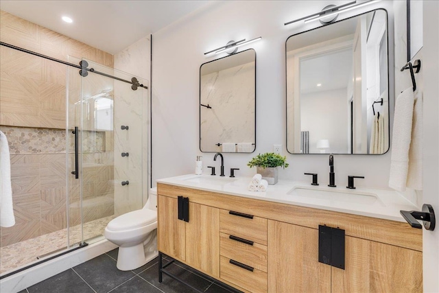 full bath with double vanity, a sink, toilet, and a shower stall