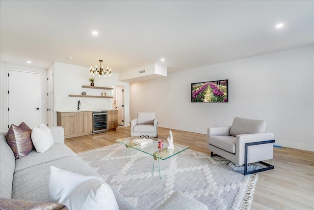 living area with light wood-type flooring, wine cooler, indoor wet bar, and recessed lighting