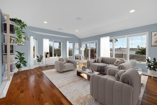 living room featuring dark hardwood / wood-style floors, vaulted ceiling, and a healthy amount of sunlight