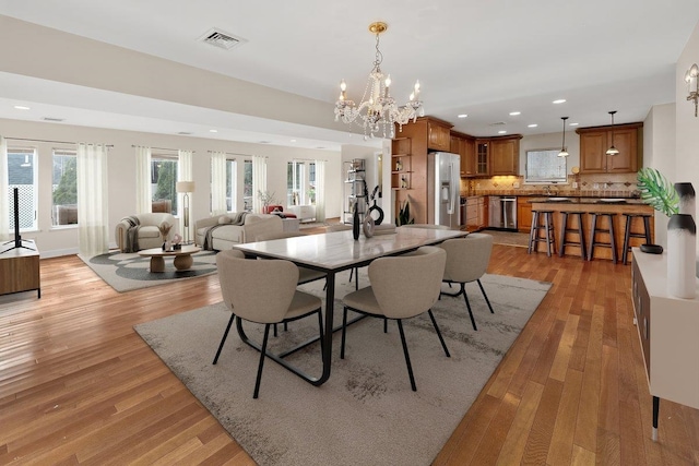 dining room featuring light hardwood / wood-style floors and an inviting chandelier