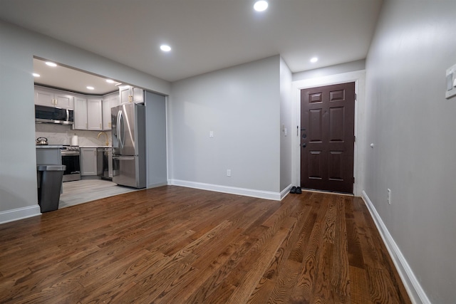 327 71st St Unit 1E, Guttenberg, NJ 07093 - unfurnished living room with recessed lighting, wood finished floors, and baseboards