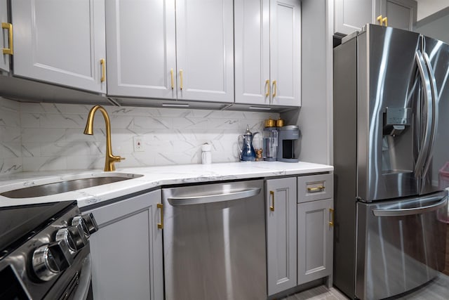 327 71st St Unit 1E, Guttenberg, NJ 07093 - kitchen with appliances with stainless steel finishes, a sink, gray cabinets, and decorative backsplash