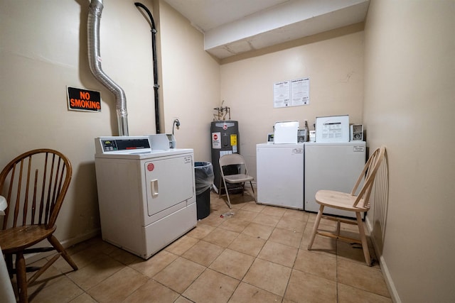 327 71st St Unit 1E, Guttenberg, NJ 07093 - communal laundry room with washer and dryer, electric water heater, light tile patterned floors, and baseboards