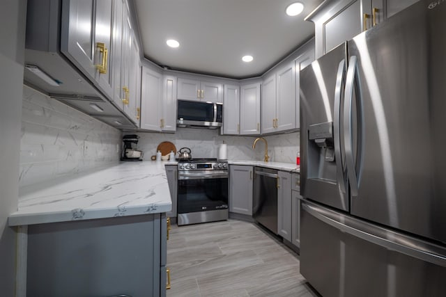 327 71st St Unit 1E, Guttenberg, NJ 07093 - kitchen with appliances with stainless steel finishes, gray cabinetry, recessed lighting, tasteful backsplash, and light stone countertops