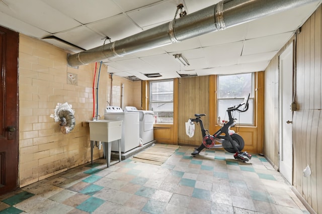 914 Washington St, Hoboken, NJ 07030 - basement with separate washer and dryer, light stone finish floors, and wood walls