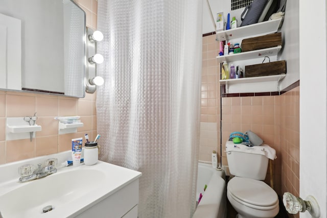 914 Washington St, Hoboken, NJ 07030 - bathroom with tile walls, vanity, and shower / bath combination with curtain