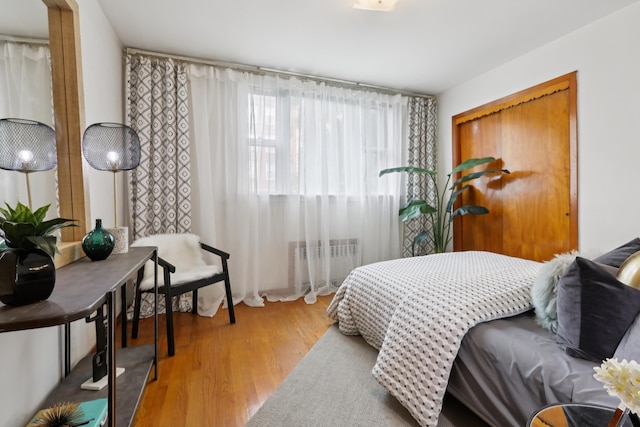 914 Washington St, Hoboken, NJ 07030 - bedroom featuring radiator and wood finished floors