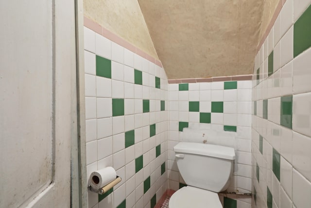 914 Washington St, Hoboken, NJ 07030 - bathroom featuring vaulted ceiling and tile walls