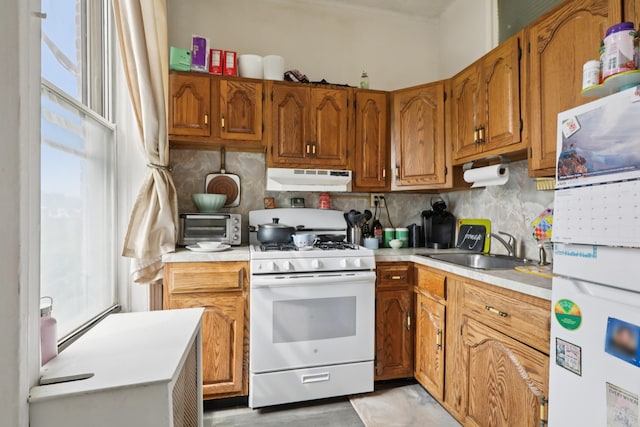 914 Washington St, Hoboken, NJ 07030 - kitchen with white appliances, under cabinet range hood, light countertops, and healthy amount of natural light