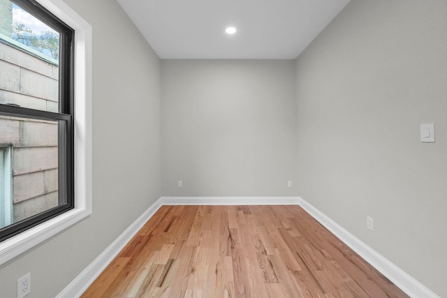 empty room with baseboards, recessed lighting, and light wood-type flooring