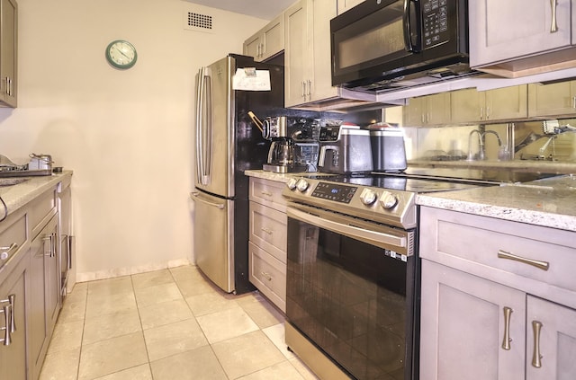 1 Claridge Dr Unit 310, Verona, NJ 07044 - kitchen with appliances with stainless steel finishes, light stone countertops, and light tile patterned floors
