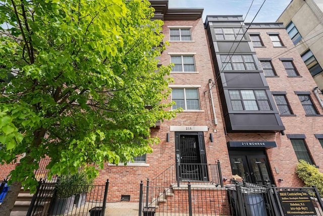 215 Monroe St Unit 3, Hoboken, NJ 07030 - view of front of property featuring brick siding and a fenced front yard