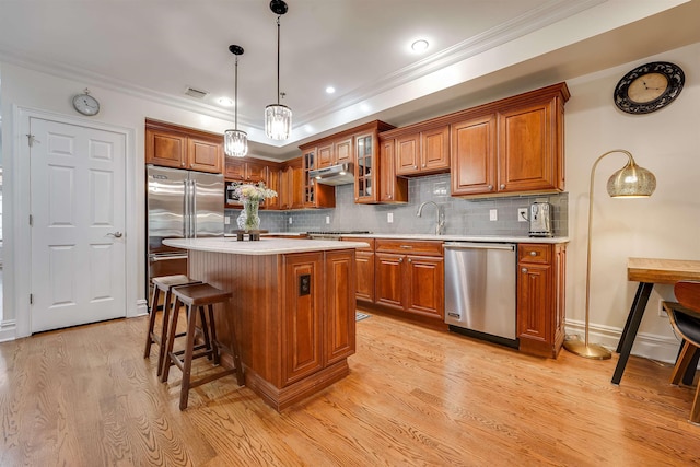 215 Monroe St Unit 3, Hoboken, NJ 07030 - kitchen featuring stainless steel appliances, brown cabinetry, light wood-type flooring, crown molding, and recessed lighting