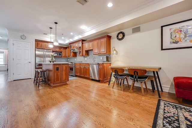 215 Monroe St Unit 3, Hoboken, NJ 07030 - kitchen featuring built in appliances, crown molding, a breakfast bar area, light countertops, and brown cabinets