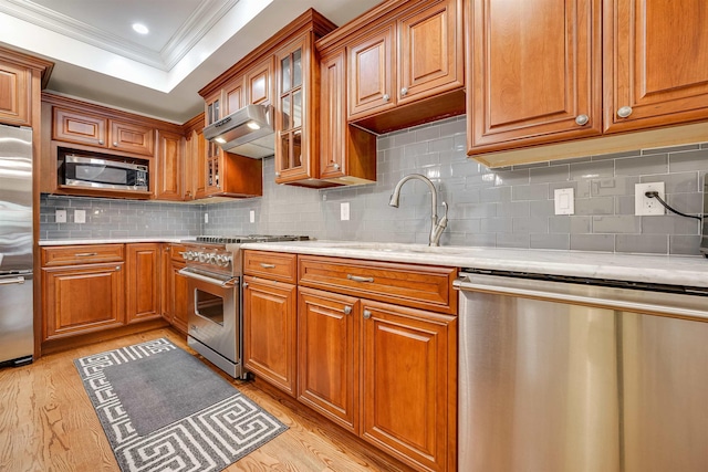 215 Monroe St Unit 3, Hoboken, NJ 07030 - kitchen with high end appliances, extractor fan, crown molding, light countertops, and light wood-style floors