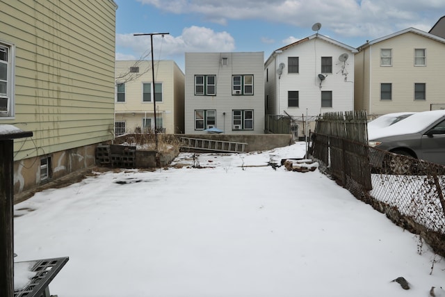 yard covered in snow featuring fence