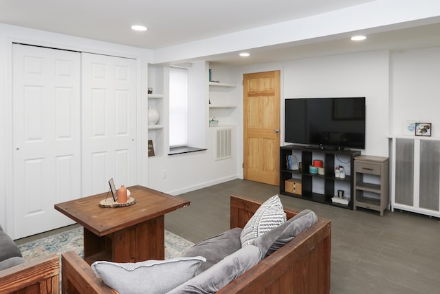 living room with visible vents, wood finished floors, and recessed lighting